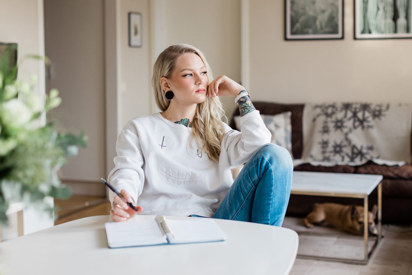 a relaxed photo of relationship coach, Katrin Berndt, dressed in a white sweater and jeans for her personal brand photo shoot