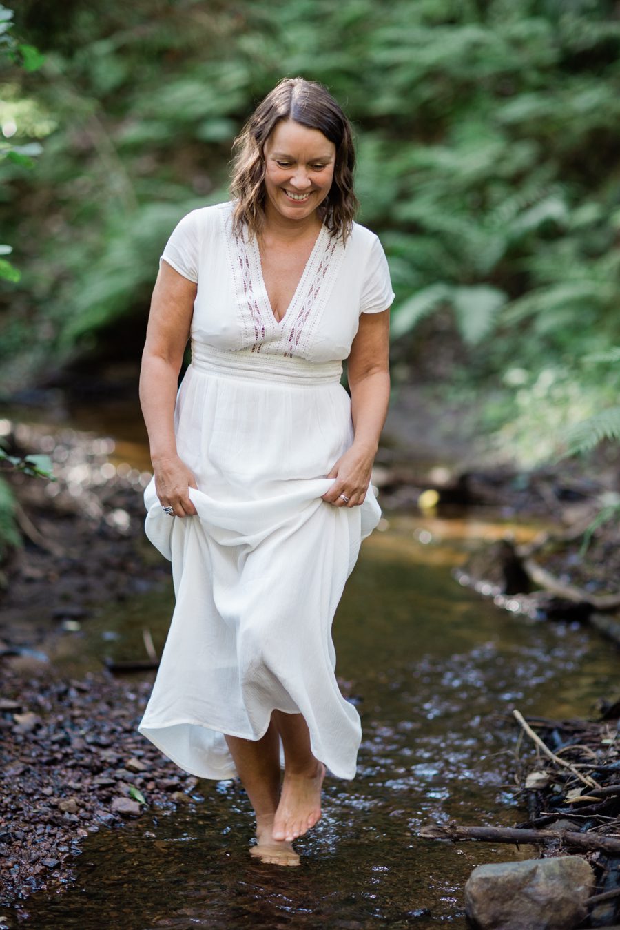 a brand photo of a coach walking in nature