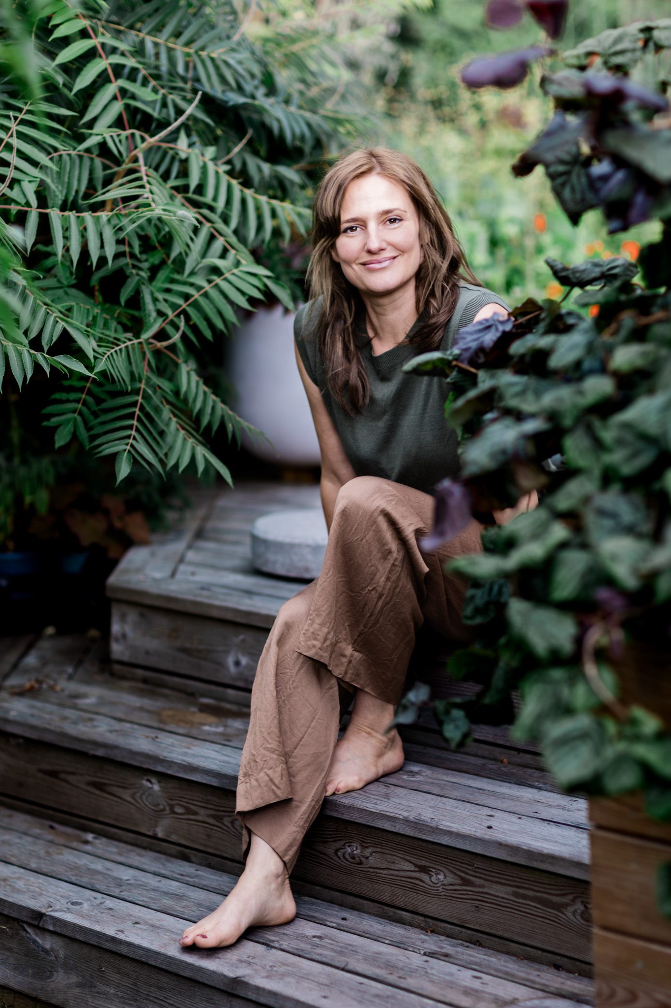 Nordic landscape designer Emma Jägbeck sitting in her garden